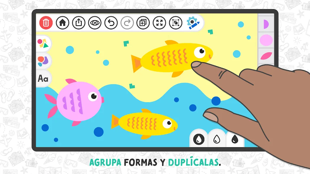Una mano duplicando un pez amarillo en Art Adventure, con el rótulo «agrupa formas y duplícalas»